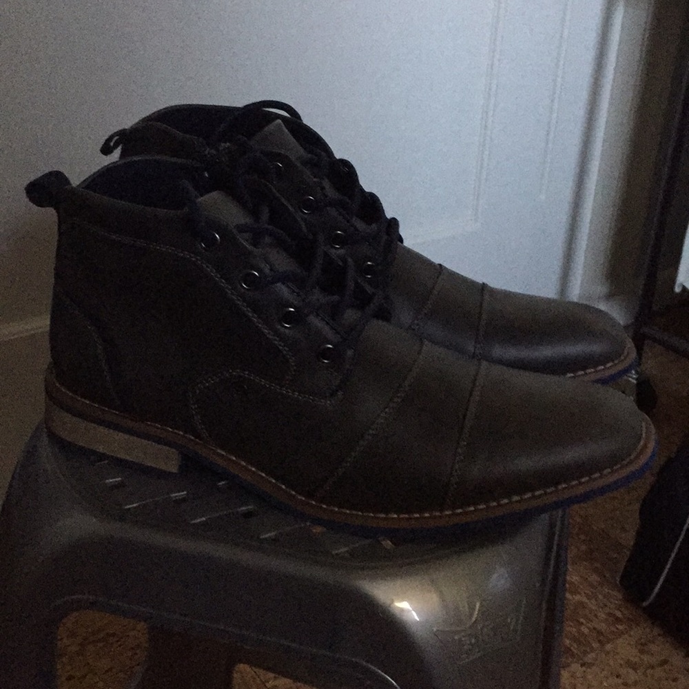 A pair of used dark grey Global Win leather boots